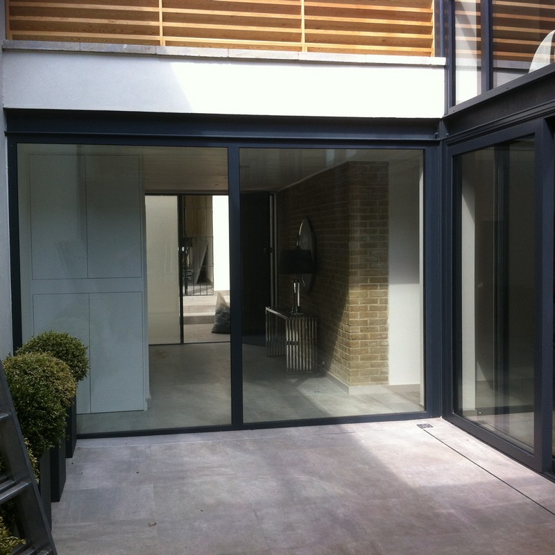 Floor-to-ceiling sliding doors opening to courtyard in Forest Hill