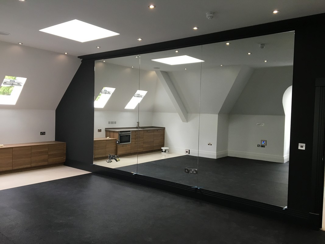Frameless glass wall dividing loft conversion in Forest Hill